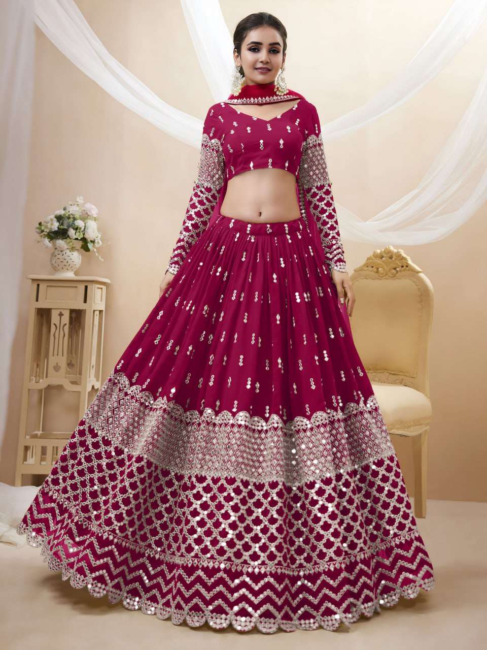 A rich hot pink colored georgette fabric lehenga with an int...