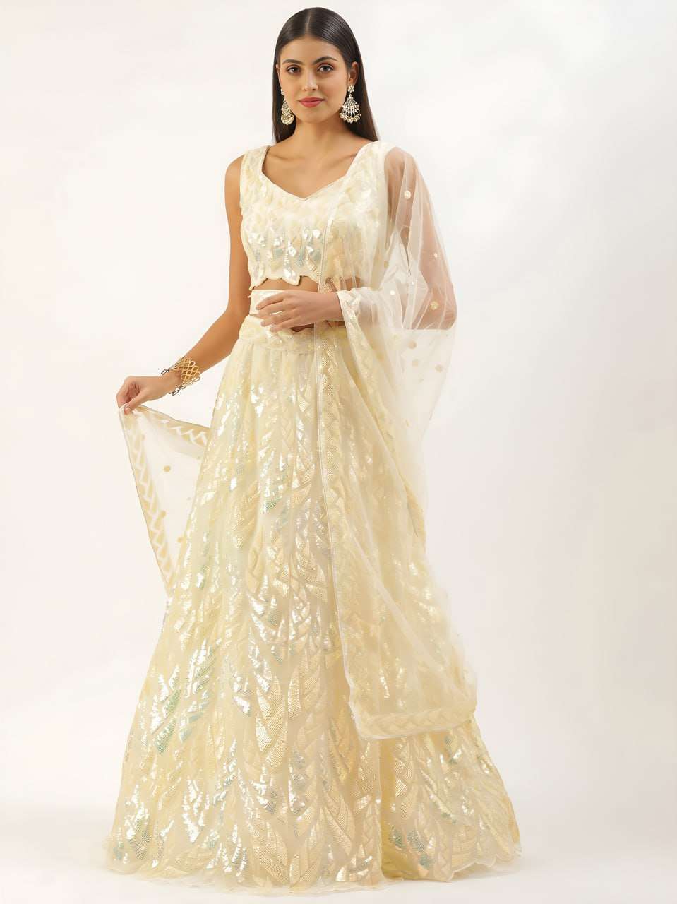 This yellow lehenga set shines with elegant sequins leaf emb...