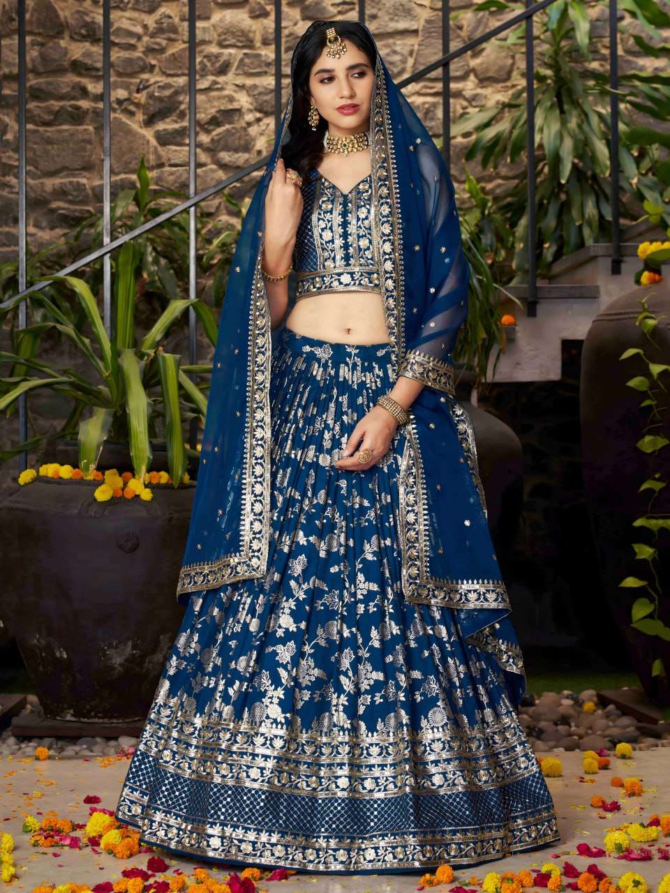   The lehenga is crafted in a dove blue dola silk jacquard ...
