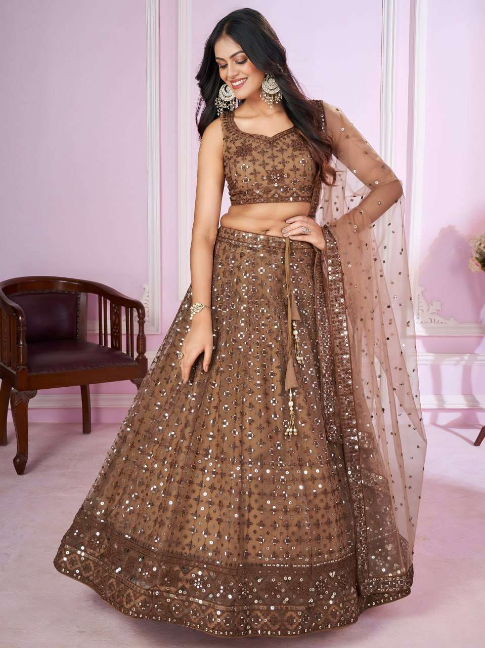  This beautiful brown lehenga choli features intricate embr...