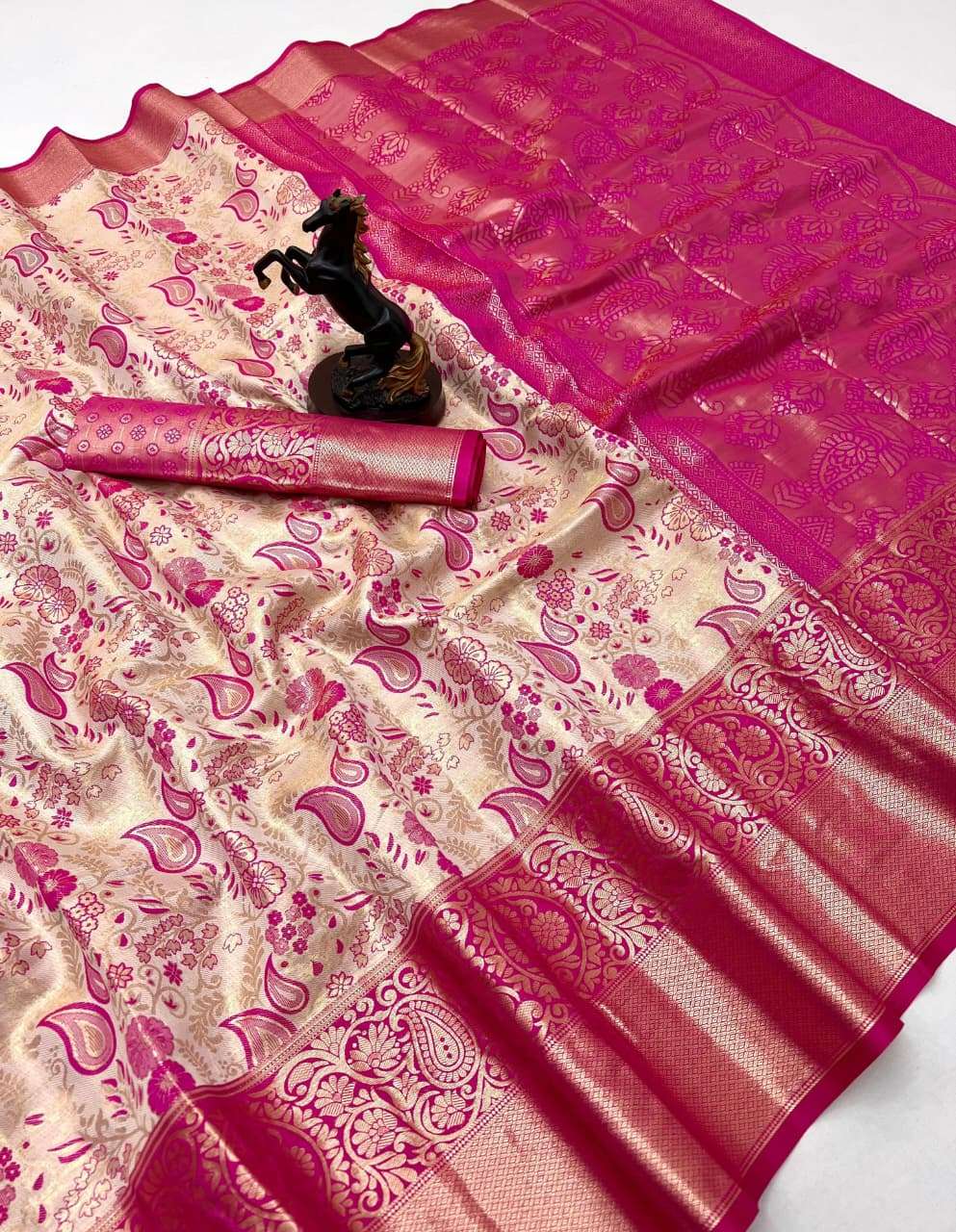 This beautiful Kanchipuram silk comes in a rich cream base S...
