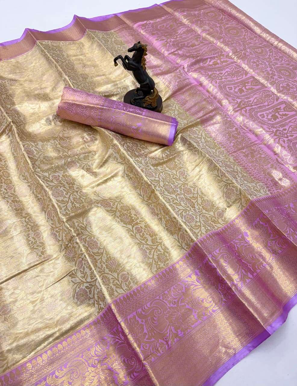 This elegant Kanchipuram silk features a rich gold base with...
