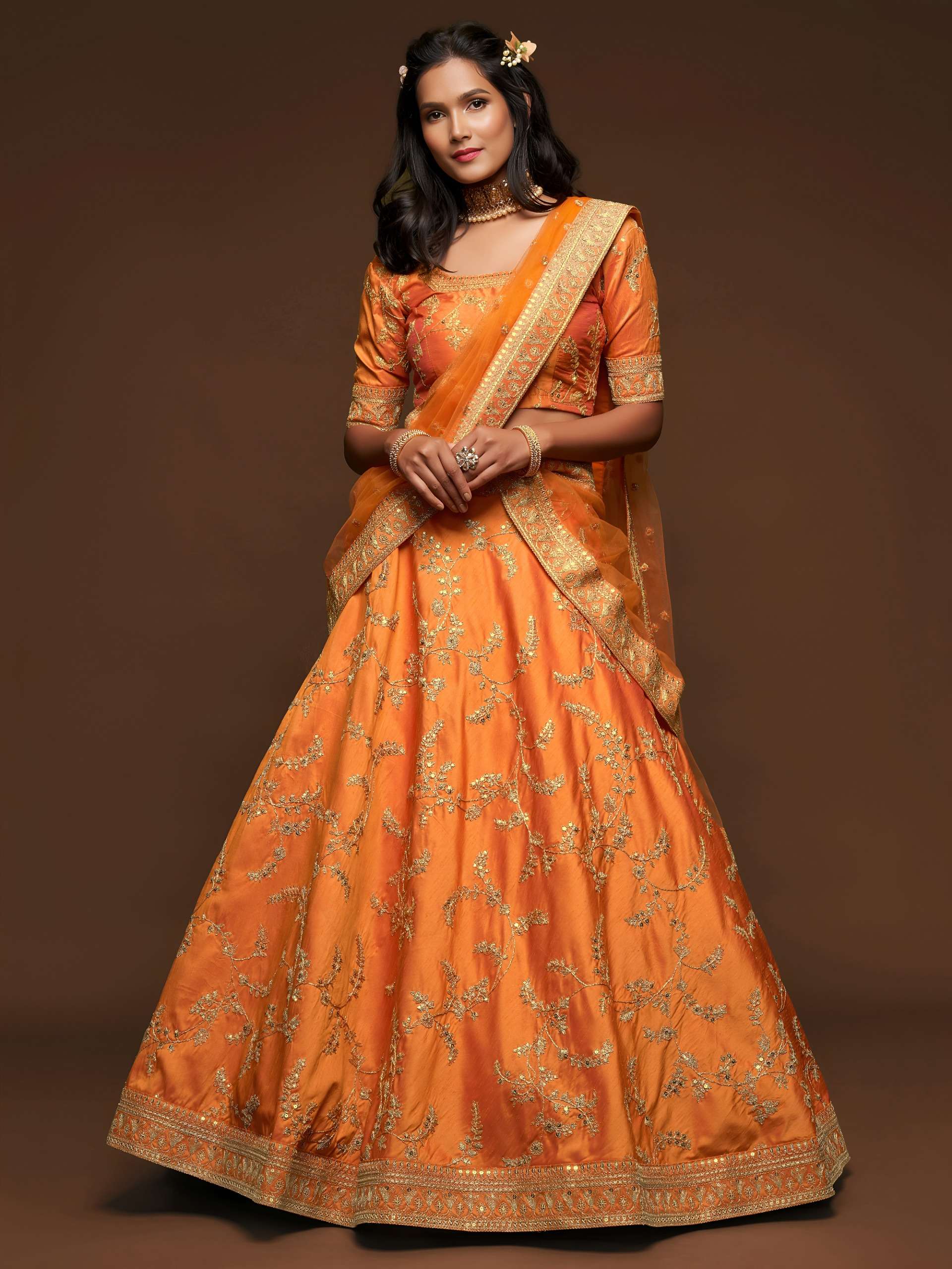 beautiful Orange colour lehenga with elegant golden floral e...