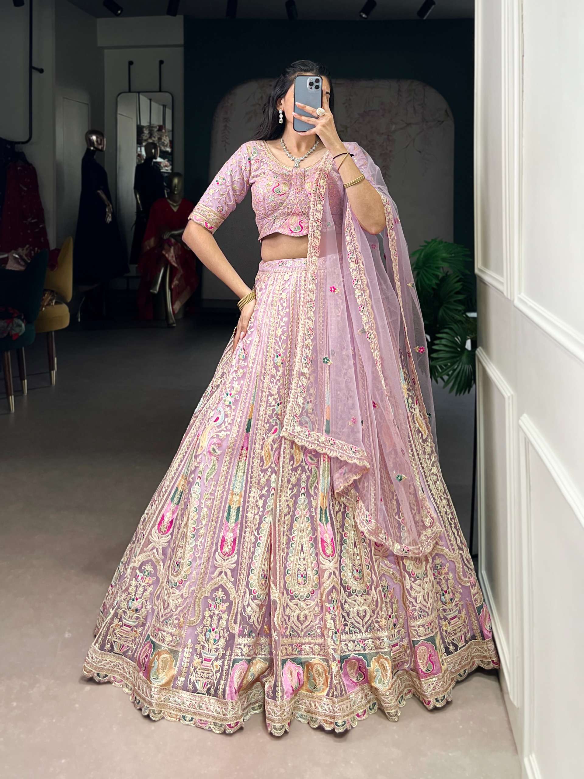 This pastel lehenga choli is a masterpiece of intricate embr...